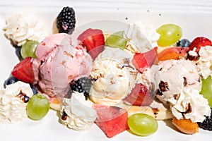Plate of healthy fresh fruit salad with ice cream. Top view