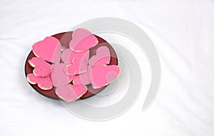 Plate of heart shaped cookies with pink frosting