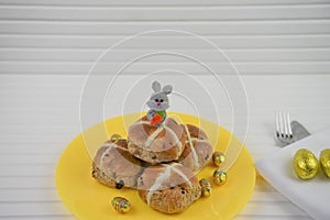 Plate of homemade hot cross buns and Easter bunny decoration