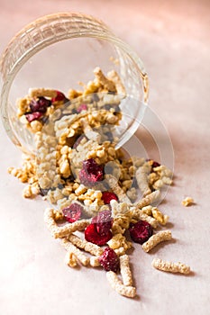 Plate of homemade muesli with cornflakes, bran, chocolate drops, freezedried cherry.