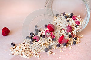 Plate of homemade muesli with cornflakes, freezedried blueberries, freezedried raspberries, linen.