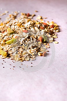 Plate of homemade muesli with cornflakes, Goji berries, chia seeds, freezedried apricot, sunflower seeds, cinnamon.