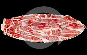 Plate of Iberian pork ham on black background. photo