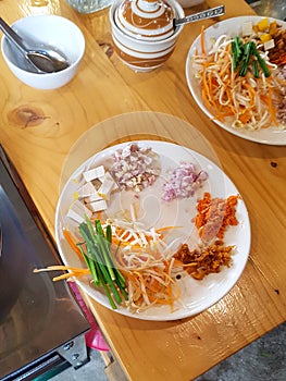 Plate with ingridients vegetables onion tofu carotte spring bowl pad thai cooking thai food chiang mai roll thailand photo