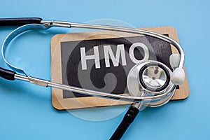 Plate with an inscription Health Maintenance Organization HMO and a stethoscope.