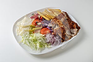 Plate of kebab with vegetables isolated