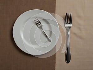 plate, knife and fork on napkin cloth