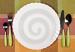 Plate with knife and fork on the table