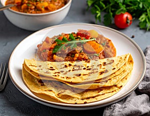 A plate of lahoh, the pancake-like flatbread, is served alongside a savory vegetable stew