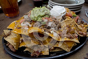 Plate of layered brisket nachos