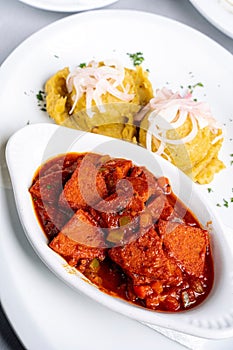 Plate of Mangu, a traditional Dominican breakfast food, served with Salami Guisado