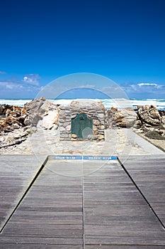 The plate marking the point of Cape Agulhas, the southernmost point of africa. The indian ocean is on the right, the Atlantic