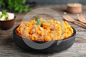 Plate with mashed sweet potatoes on table