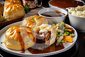 plate of meat pies, with sides of mashed potatoes and gravy