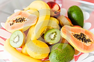 Plate of mixed exotic fruit on the kitchen table