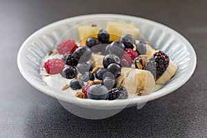 Plate of mixed fruits with yogurt