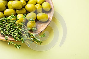 Plate of olives and aromatic thyme herbs