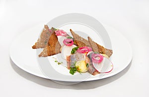 Plate of omul fish with bread and onion on white