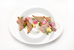 Plate of omul fish with bread and onion on white