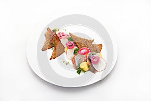 Plate of omul fish with bread and onion on white