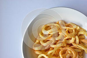 Plate with onion rings snacks on a white background