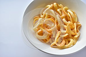Plate with onion rings snacks on a white background