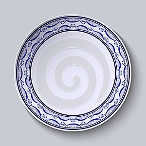Plate with ornament in gzhel style of painting on porcelain. Thin pattern with flowers on the edge.