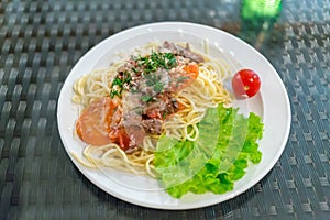 plate of pasta with meat, vegetables and photo