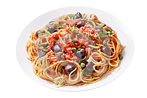 Plate of pasta puttanesca with olives, tomato sauce, anchovies and capers on white background