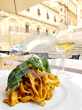 Plate of pasta and wine.