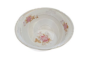 Plate with a pattern of flowers isolated on a white background. Ceramic tableware. Porcelain kitchenware