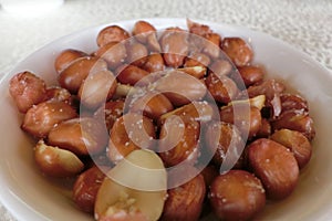 A plate of peanuts with salts