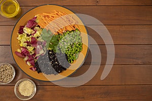 Plate of peas, black rice, carrots and mixed salad. Fresh and summer salad