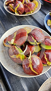 a plate of peeled archidendron pauciflorum kernel seeds vegetable.