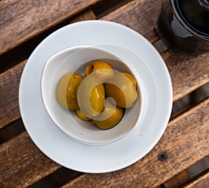 Plate of pickled green olives without stone, spanish appetizer - Olivas verdes sin hueso photo