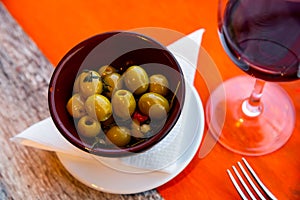 Plate of pickled green olives without stone, spanish appetizer - Olivas verdes sin hueso photo