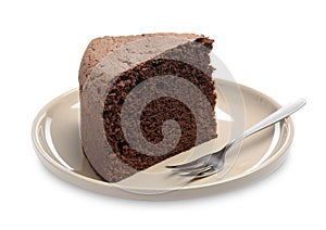 Plate with piece of chocolate sponge cake and fork isolated on white