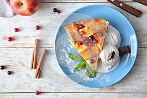 Plate with piece of delicious apple pie and ice cream on wooden background