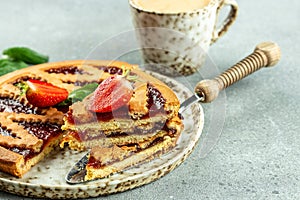 Plate with piece of tasty strawberry pie with Cup of coffee. menu, dieting, cookbook recipe top view