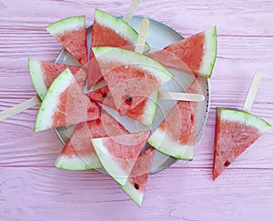 Plate of a piece of watermelon snack refreshment on a wooden background photo