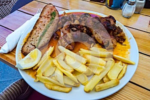 Plate of pig`s feet with grapes with a slice of bread