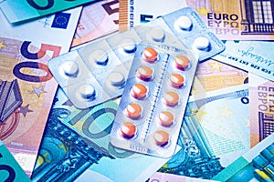 Plate with pills on the background of euro bills.