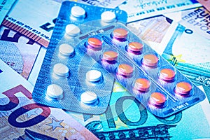 Plate with pills on the background of euro bills. The concept of the expensive cost of healthcare