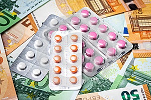 Plate with pills on the background of euro bills