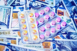 Plate with pills on the background of one hundred dollar bills. The concept of the expensive cost of healthcare or financing