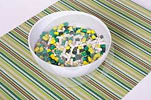Plate of pills on striped cloth isolated, concept diet