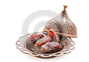 Plate of pitted dates isolated on a white background photo