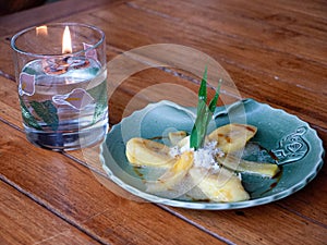 Plate of plantains with a candle