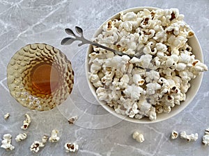 A plate of popcorn, a plate of honey.