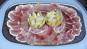 Plate with raw bacon and melone flower